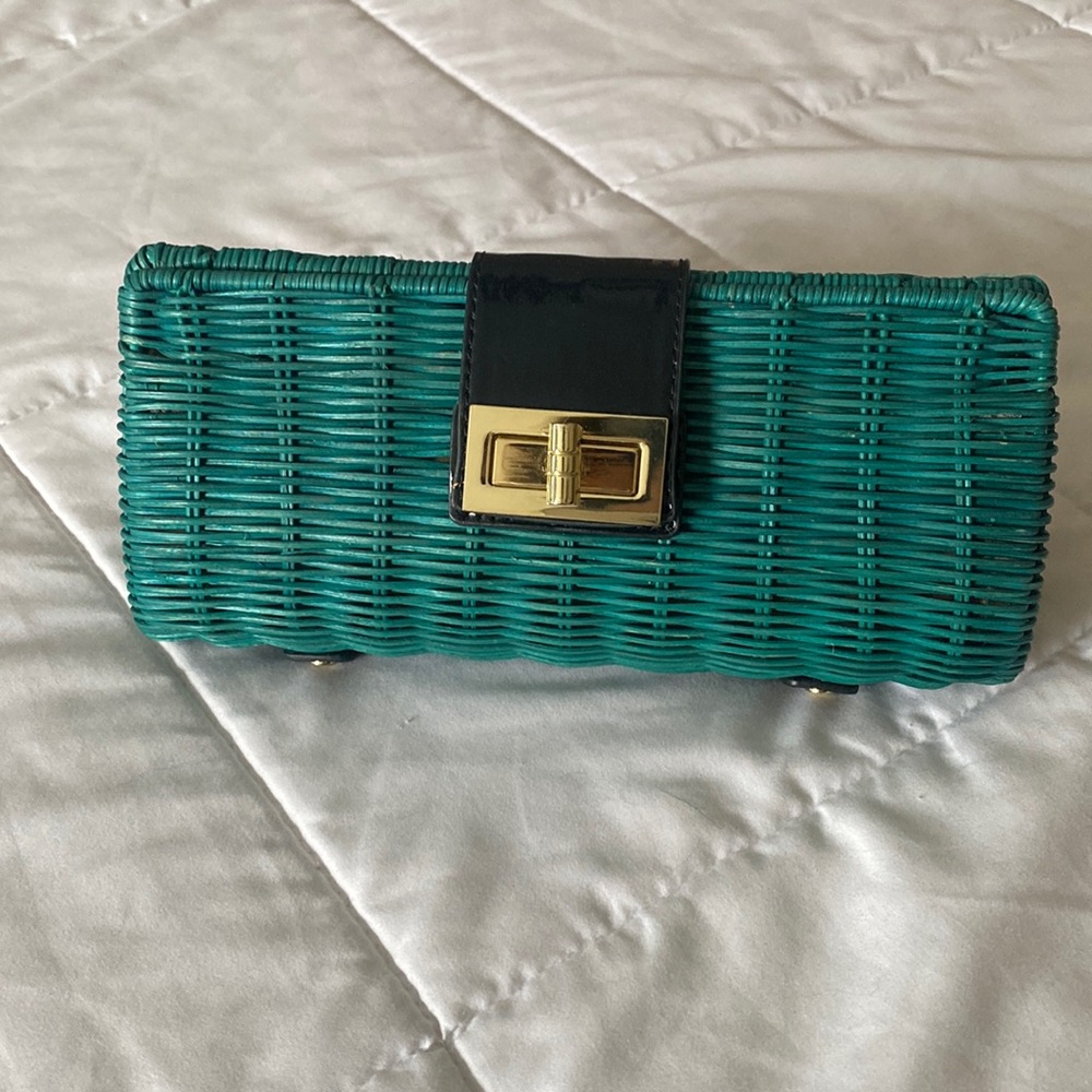 Green wicker clutch with gold hardware.